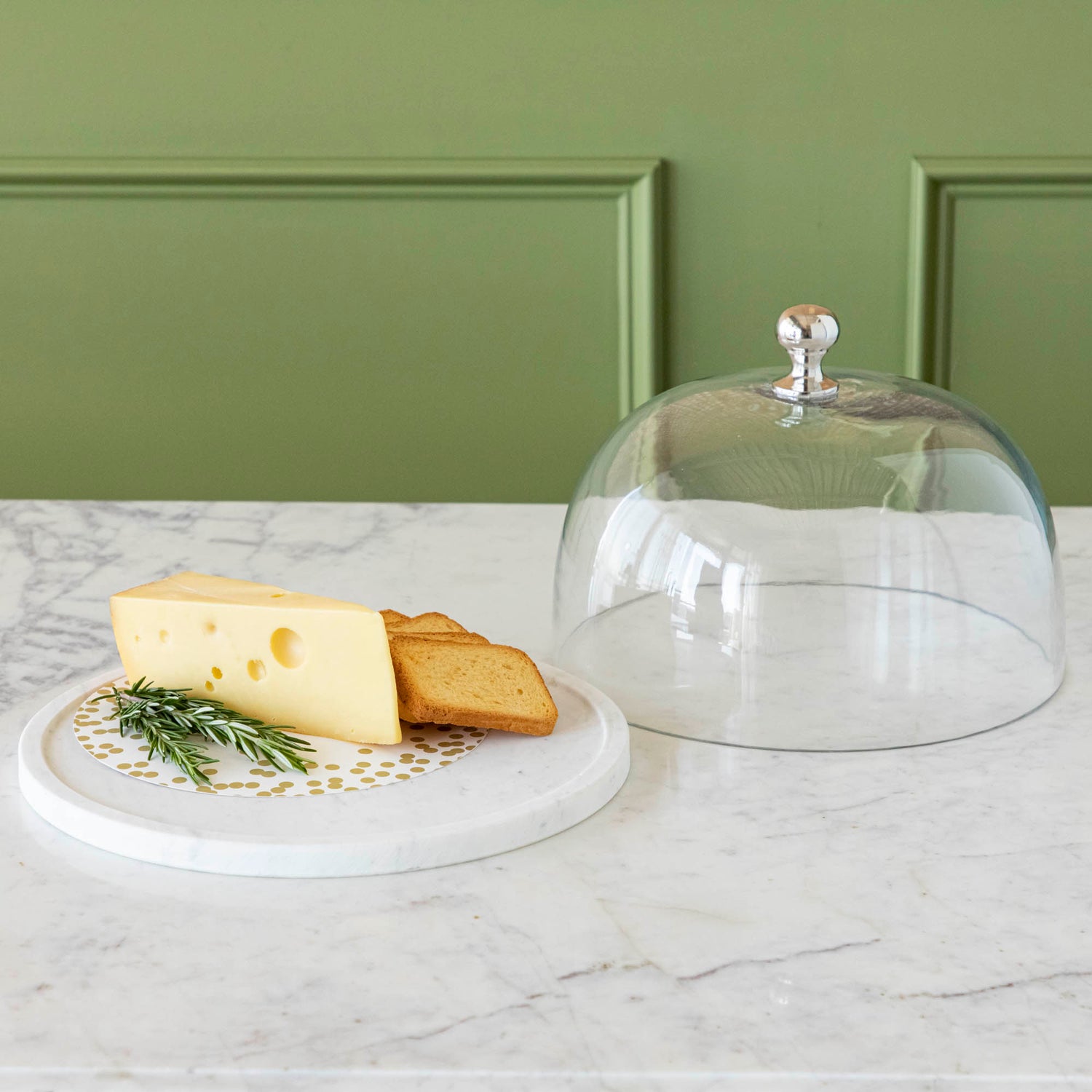 Chocolate muffins under a Bidk Home Marble &amp; Glass Food Dome with Knob, 11.5&quot; Diameter, presented on a white marble plate.