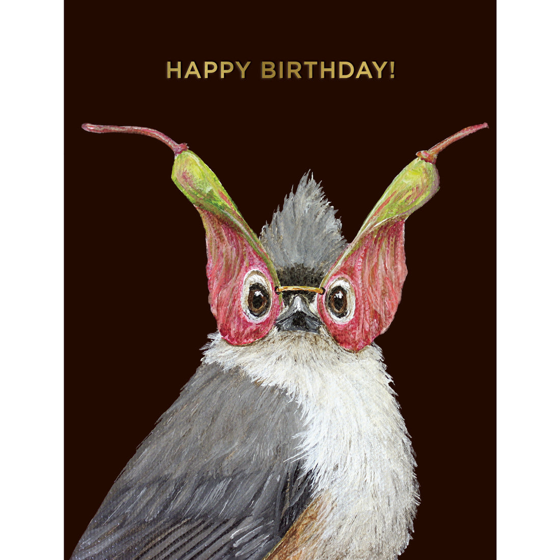 A dark brown greeting card featuring a charming illustrated portrait of a songbird wearing a mask made of seed pods, with the words &quot;HAPPY BIRTHDAY!&quot; printed in gold foil across the top of the card. 