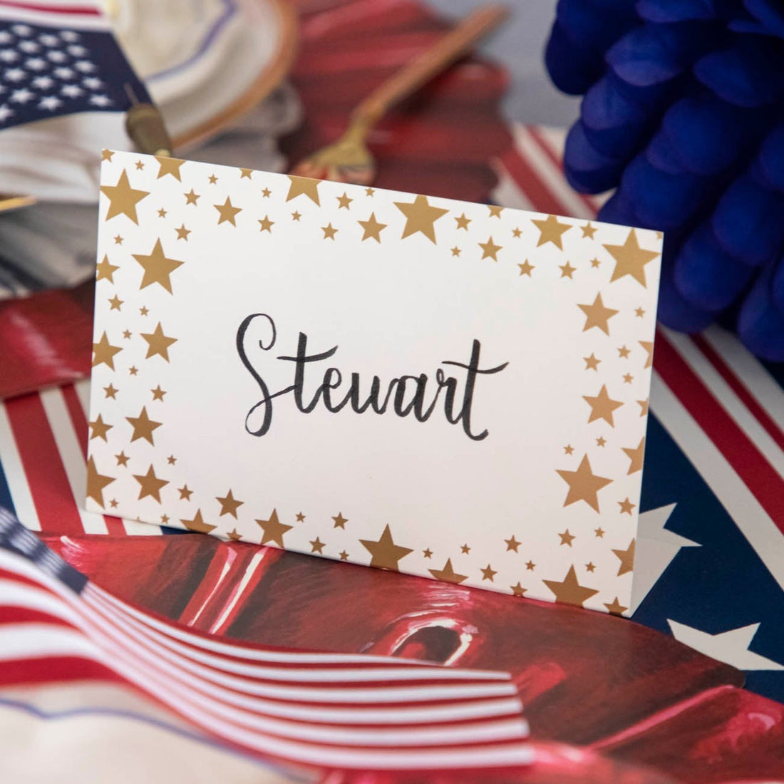 Close-up of a Shining Star Place Card labeled &quot;Steward&quot; on a patriotic tablescape.