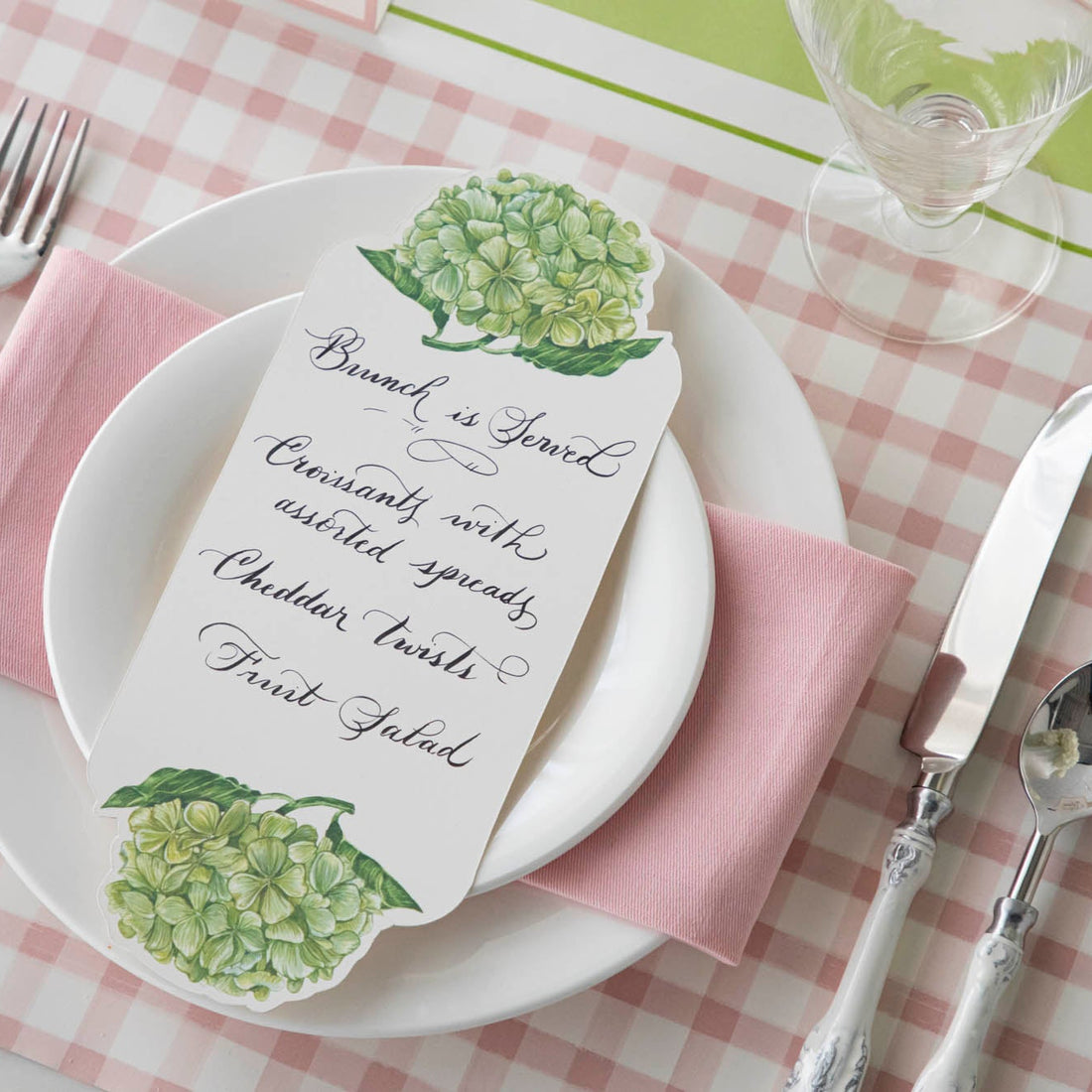 The Pink Painted Check Placemat under an elegant place setting, from above.