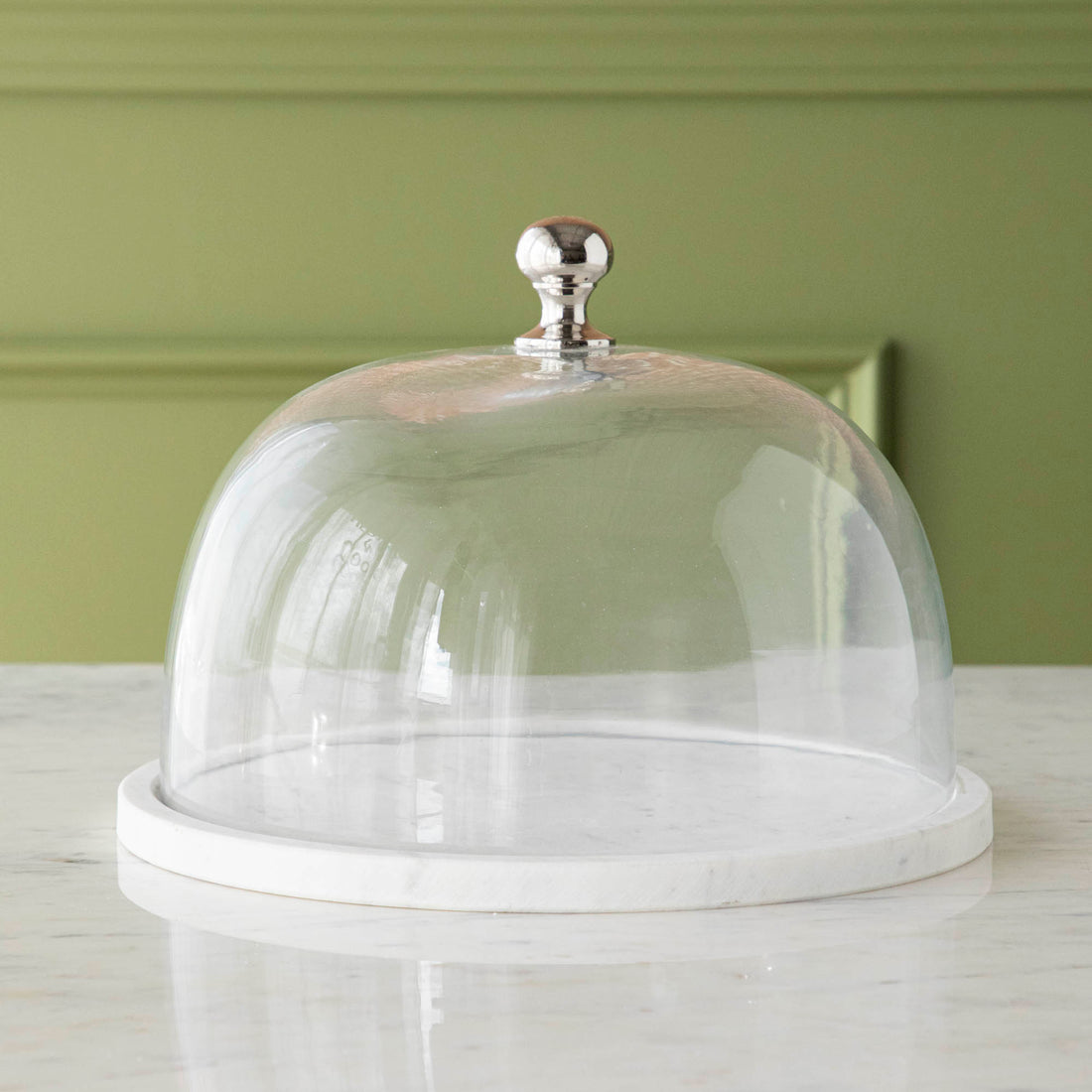 Chocolate muffins under a Bidk Home Marble &amp; Glass Food Dome with Knob, 11.5&quot; Diameter, presented on a white marble plate.