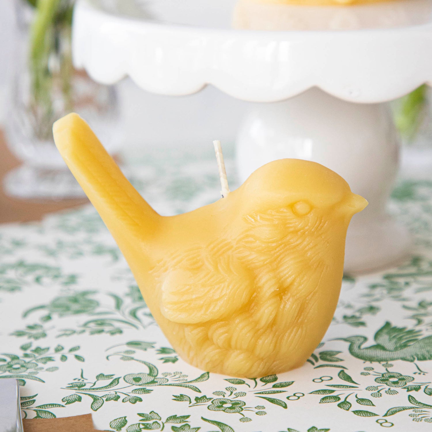Two hand-casted Beeswax Songbirds Candles adorned with birds by Big Dipper Wax Works.