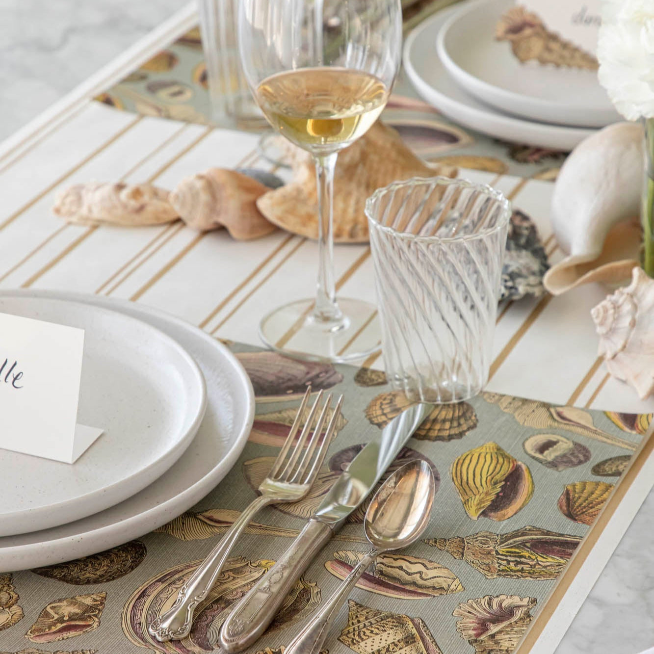 Shell Study Placemat under an elegant place setting.