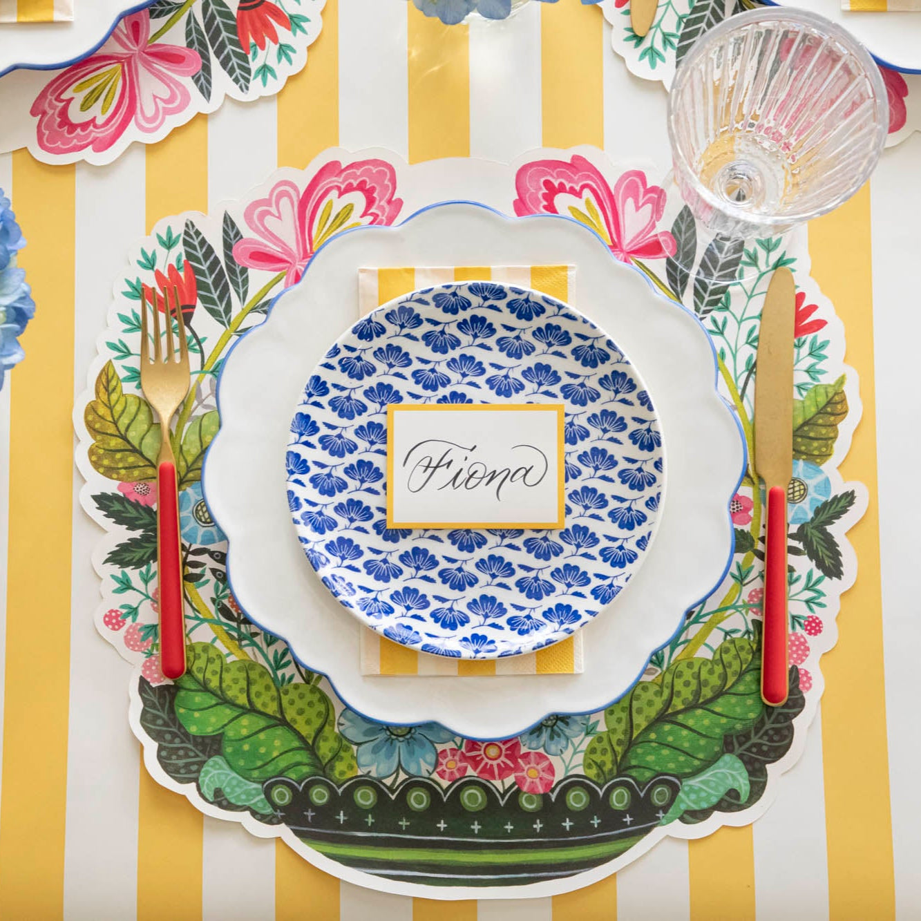 Die-cut Vase Arrangement Placemat under a floral themed place setting for one.