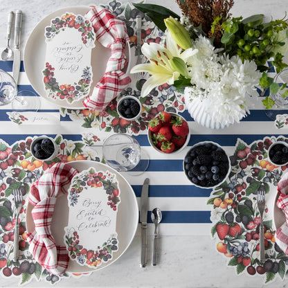 The Die-cut Berry Wreath Placemat under an elegant table setting for four, from above.