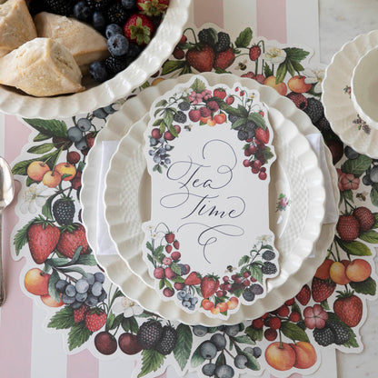 The Die-cut Berry Wreath Placemat under an elegant place setting, from above.