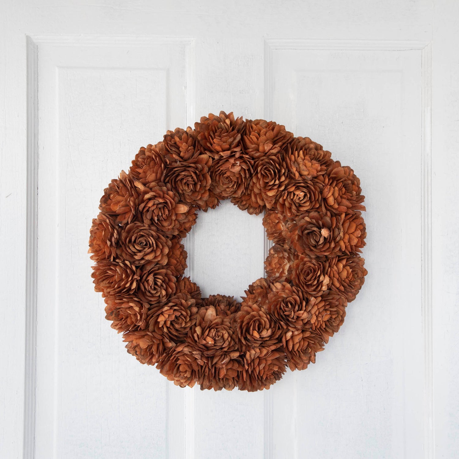 Sunset Shola Almond Flower Wreath hanging on door