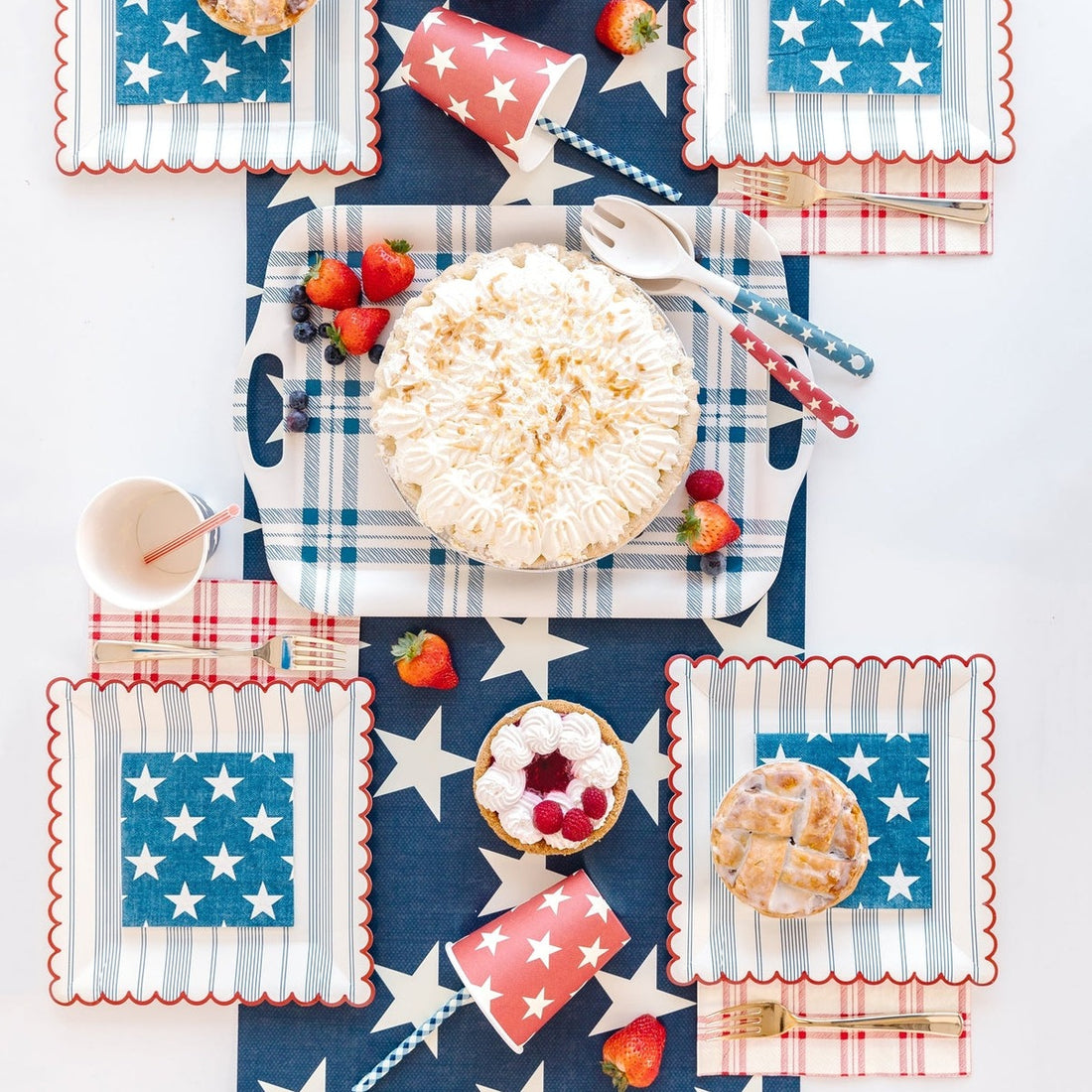 Red, white &amp; blue themed table setting with the Navy Star Cocktail Napkin in the center of the plates.