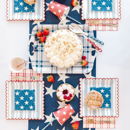 Red, white &amp; blue themed table setting with the Navy Star Cocktail Napkin in the center of the plates.