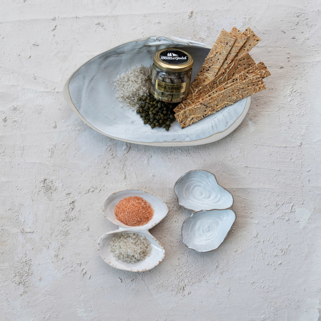 White Stoneware Shell Shaped Dishes on the sand. 
