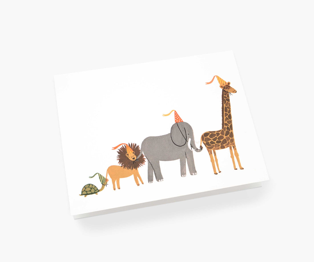 Greeting card featuring illustrations of a turtle, lion, elephant, and giraffe on natural white cover paper from Rifle Paper Co.&