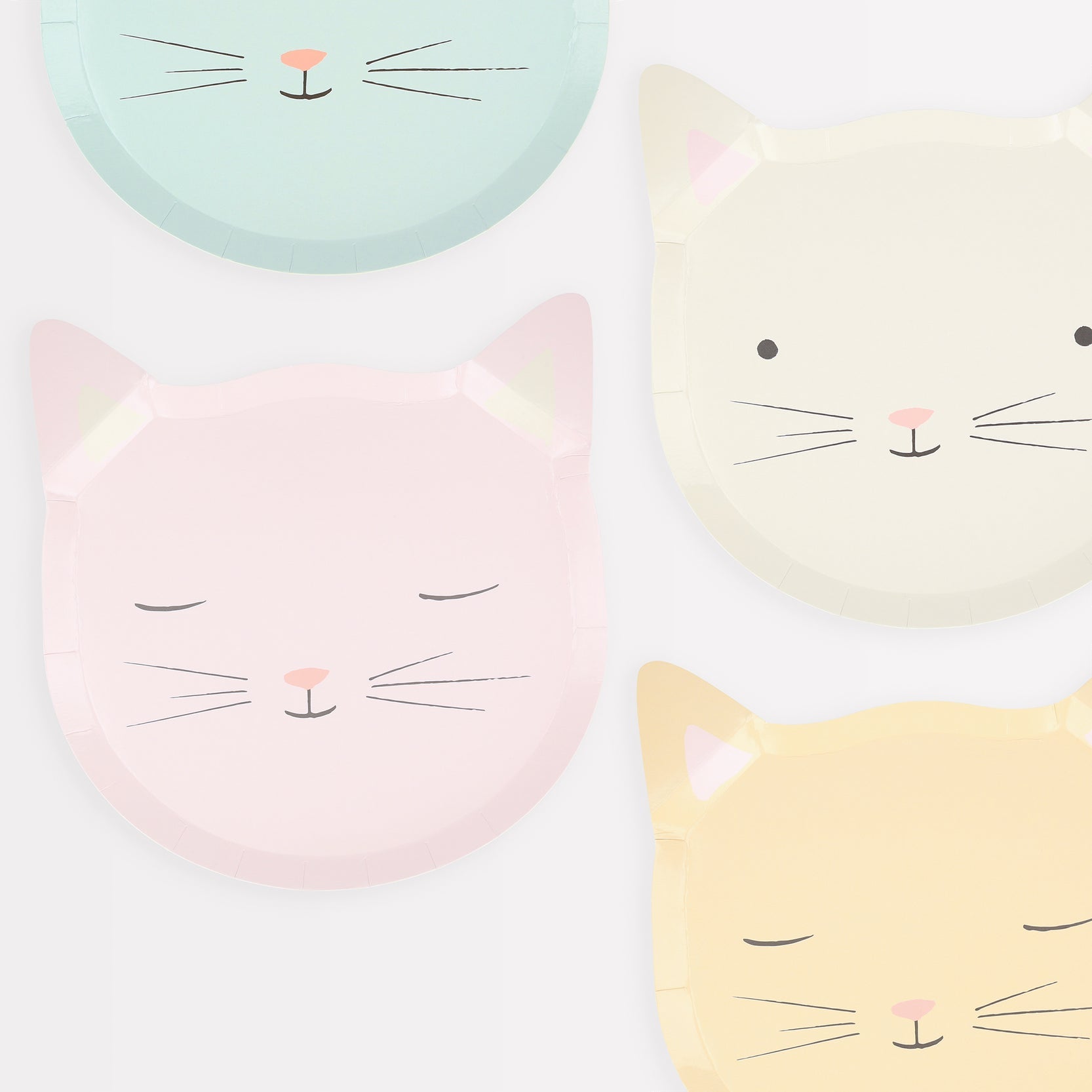 Four Meri Meri Cat Plates with cartoon cat faces in pastel colors, made from sustainable FSC paper.