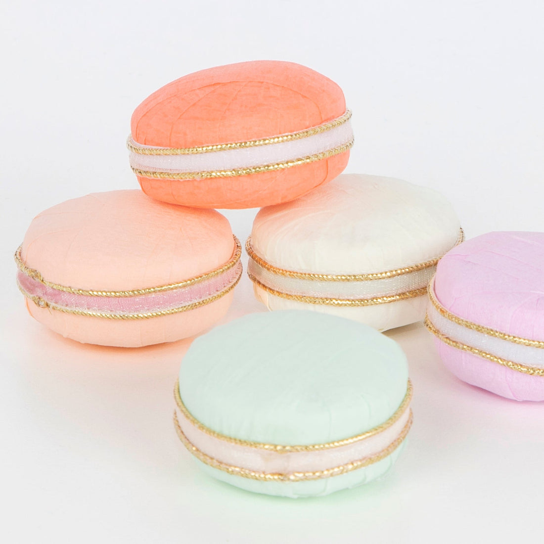 A group of Ladurée Paris Macaron Surprise Balls, arranged beautifully on a white surface.