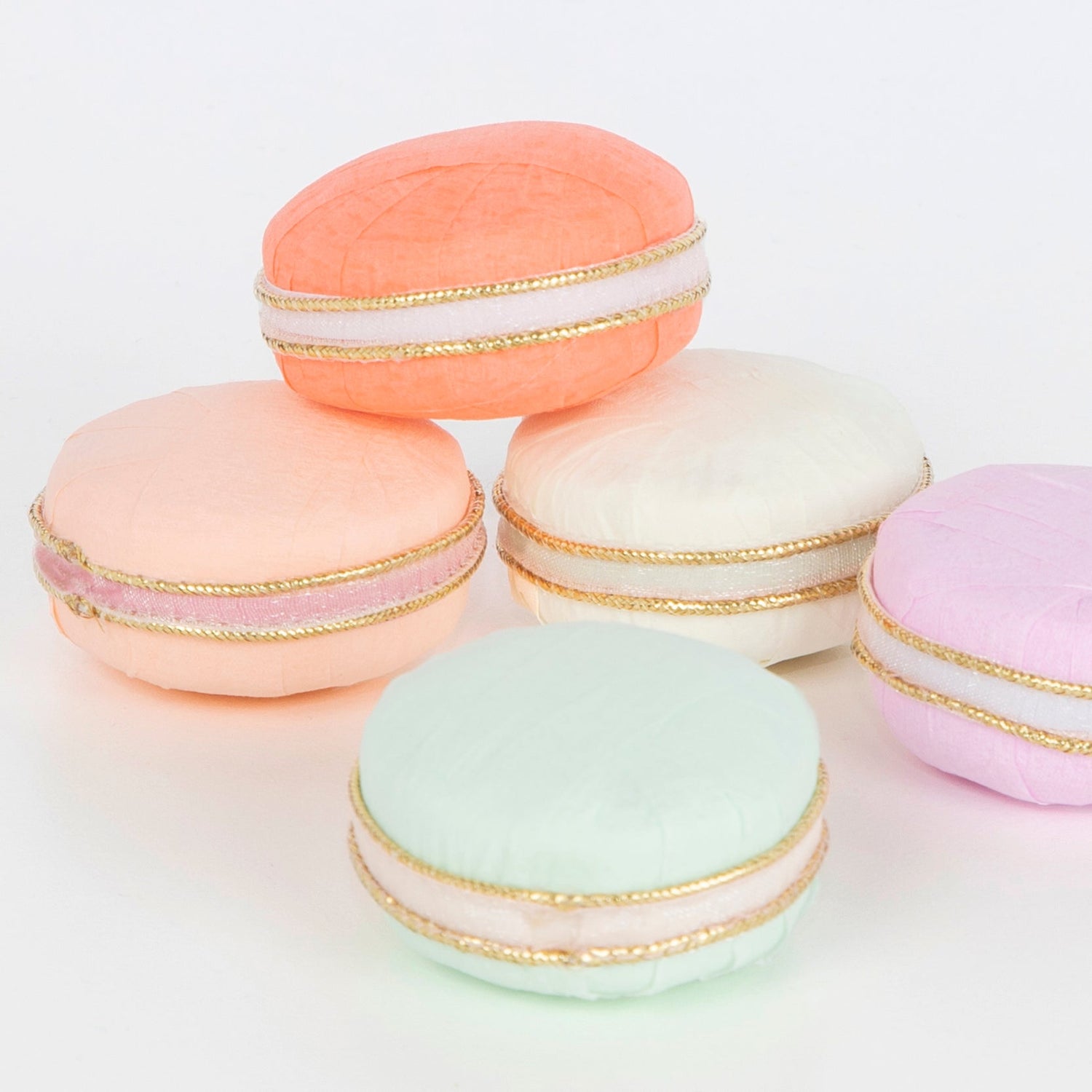 A group of Ladurée Paris Macaron Surprise Balls, arranged beautifully on a white surface.