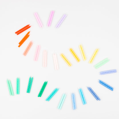 A set of Rainbow Twisted Mini Candles by Meri Meri in a box, perfect for a celebratory party theme.