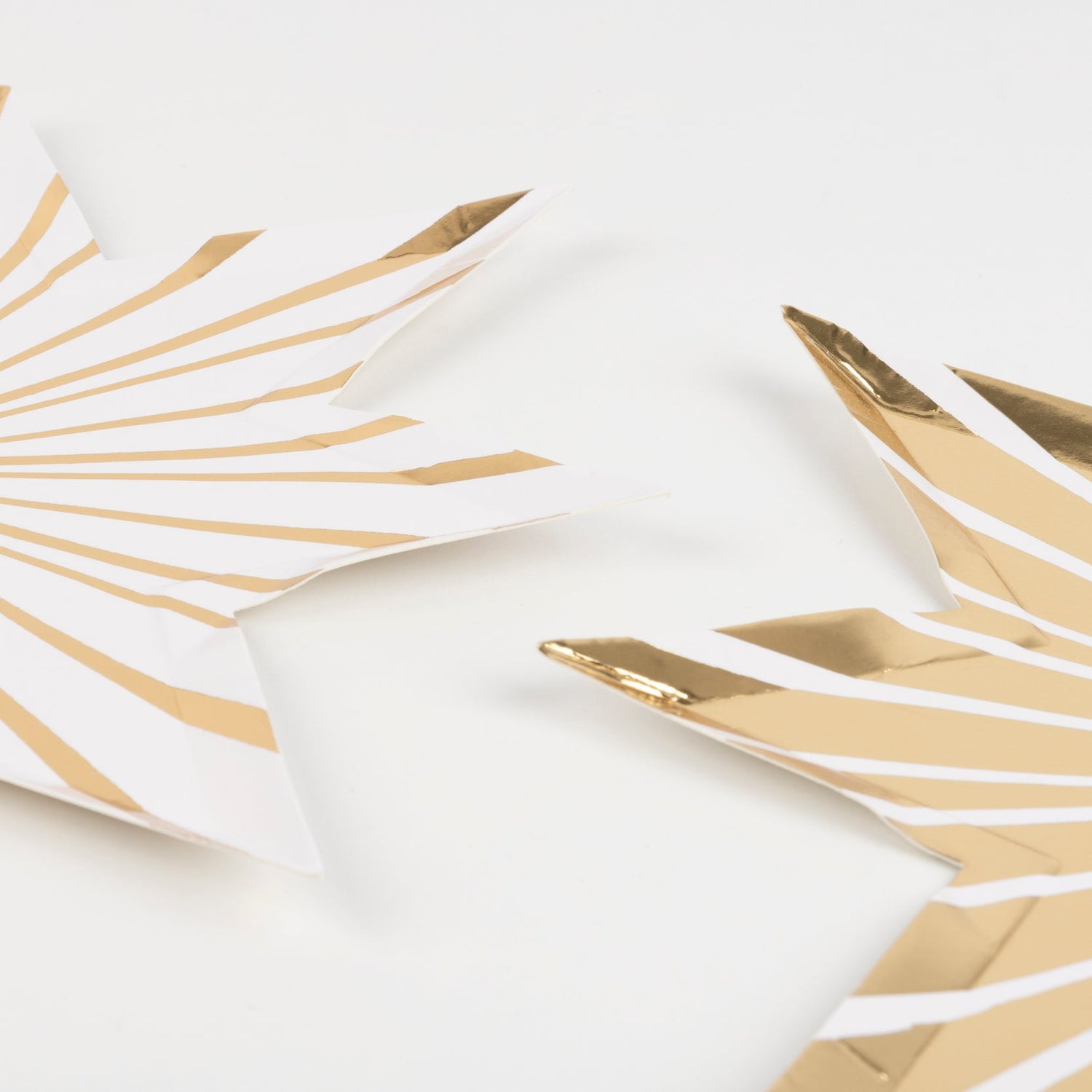 Two Meri Meri Gold Stripe Star Plates on a white background.