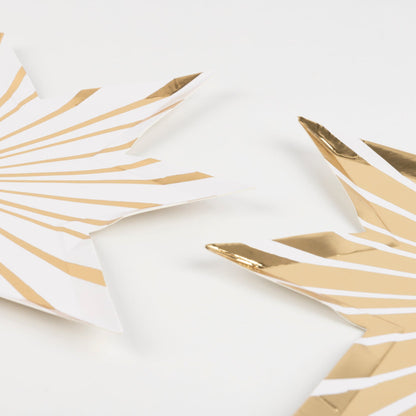 Two Meri Meri Gold Stripe Star Plates on a white background.
