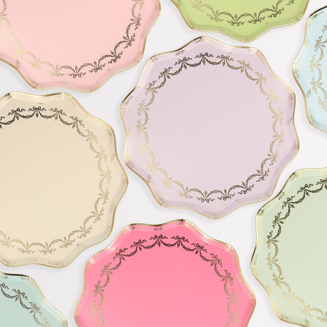 A group of Meri Meri Ladurée Paris Paper Plates with gold foil accents.