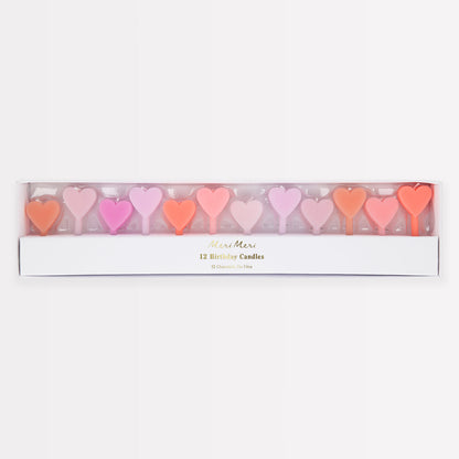 A set of 12 wax heart candles in 7 shades of pink by Meri Meri. 