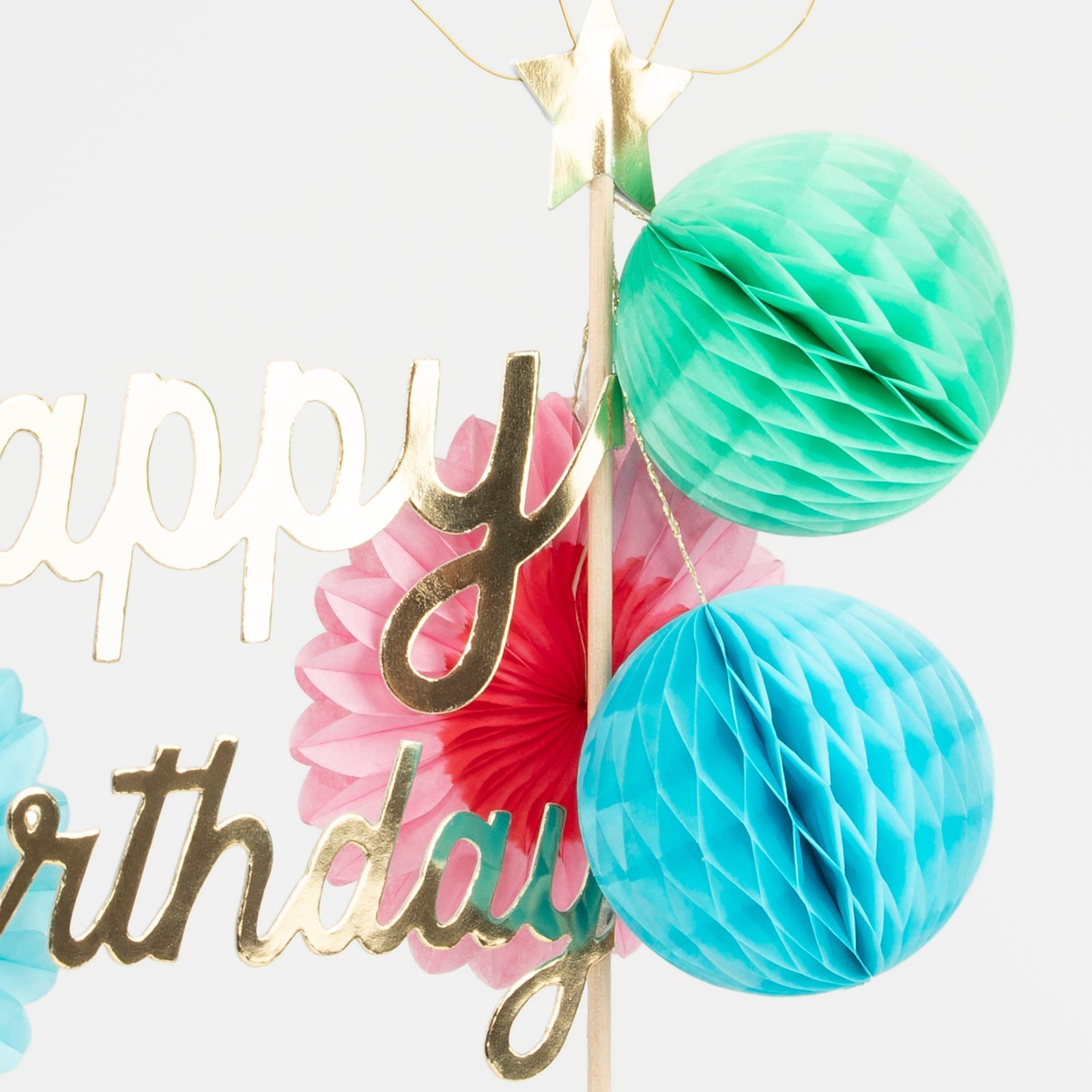 A close up of the Happy Birthday Honeycomb Cake Topper showing the colorful honeycomb balls and shiny gold &quot;Happy Birthday&quot; words.