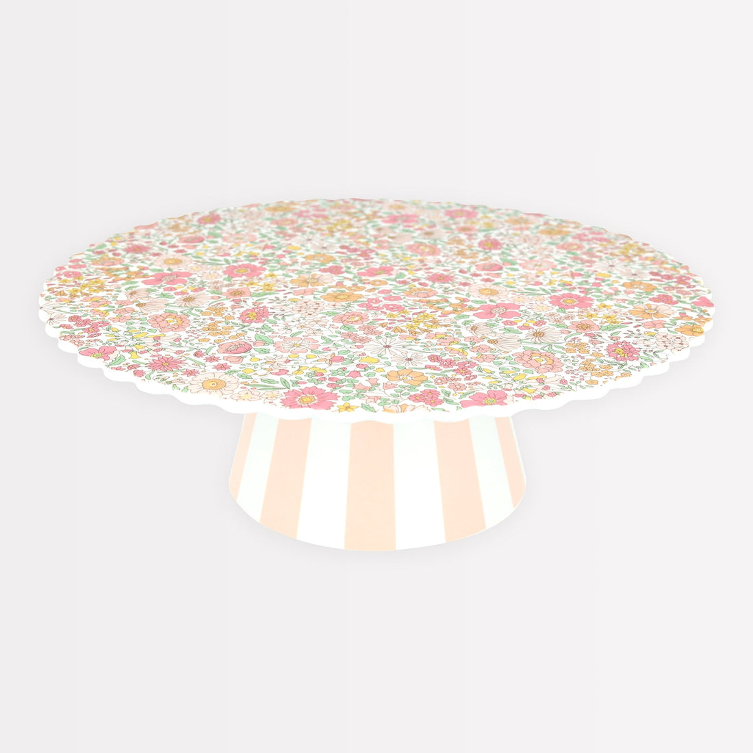 Meri Meri x Liberty Reusable Cake Stand with Liberty floral print in pinks, yellows and oranges on top and a pink and white striped base. 