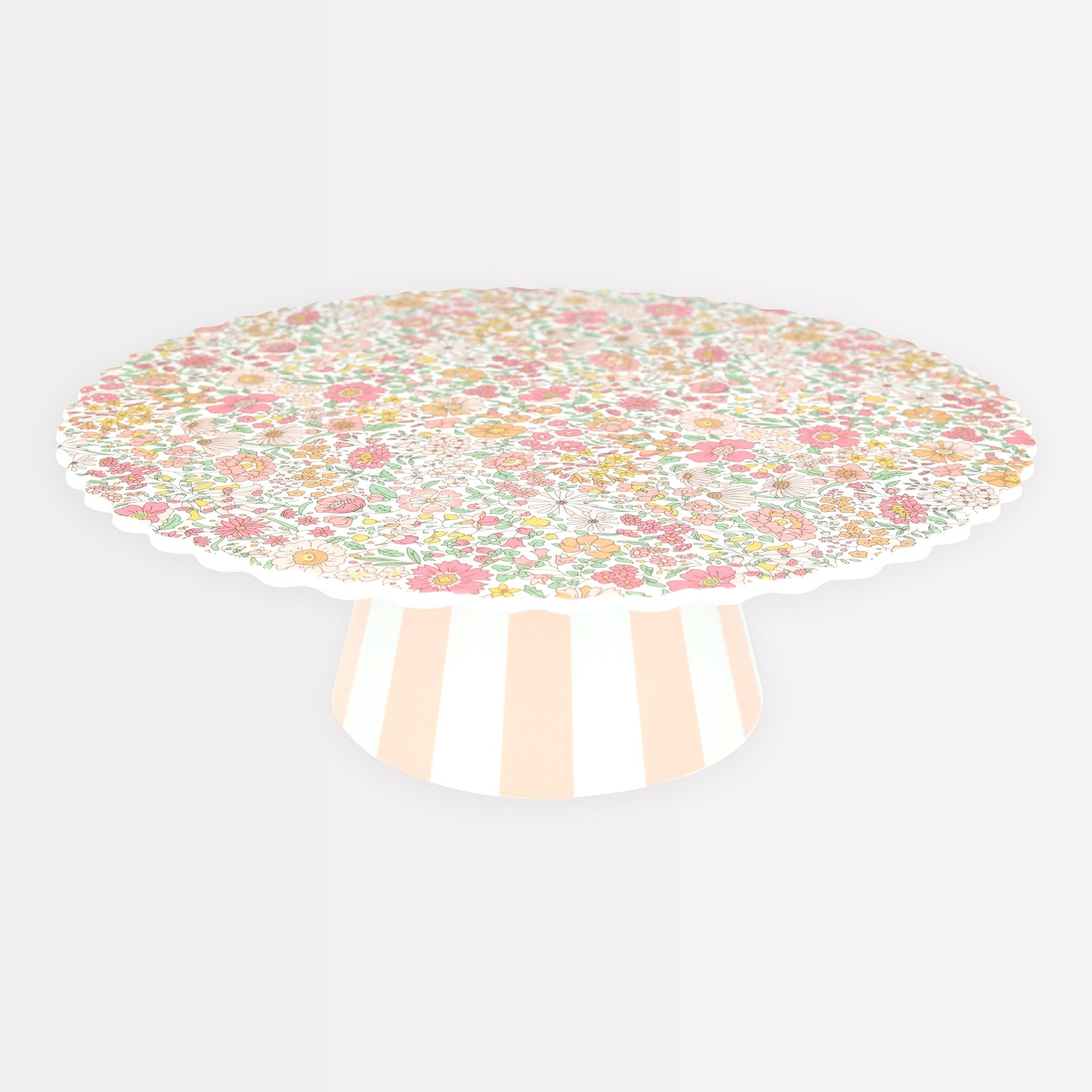 Meri Meri x Liberty Reusable Cake Stand with Liberty floral print in pinks, yellows and oranges on top and a pink and white striped base. 
