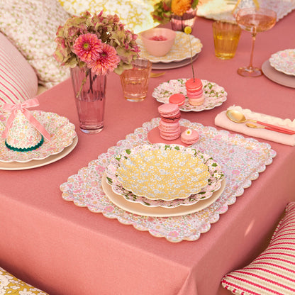 Lifestyle of Meri Meri x Liberty plate on a set table with flowers and macaroons. 