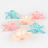 6 Surprise balls with big velvet ribbon bows in pink, peach and blue and wrapped in crepe paper layers of pale yellow, light pink and mint.