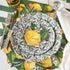 Elegant table setting with Burleigh Green Prunus Dinnerware plates and green striped tablecloth.