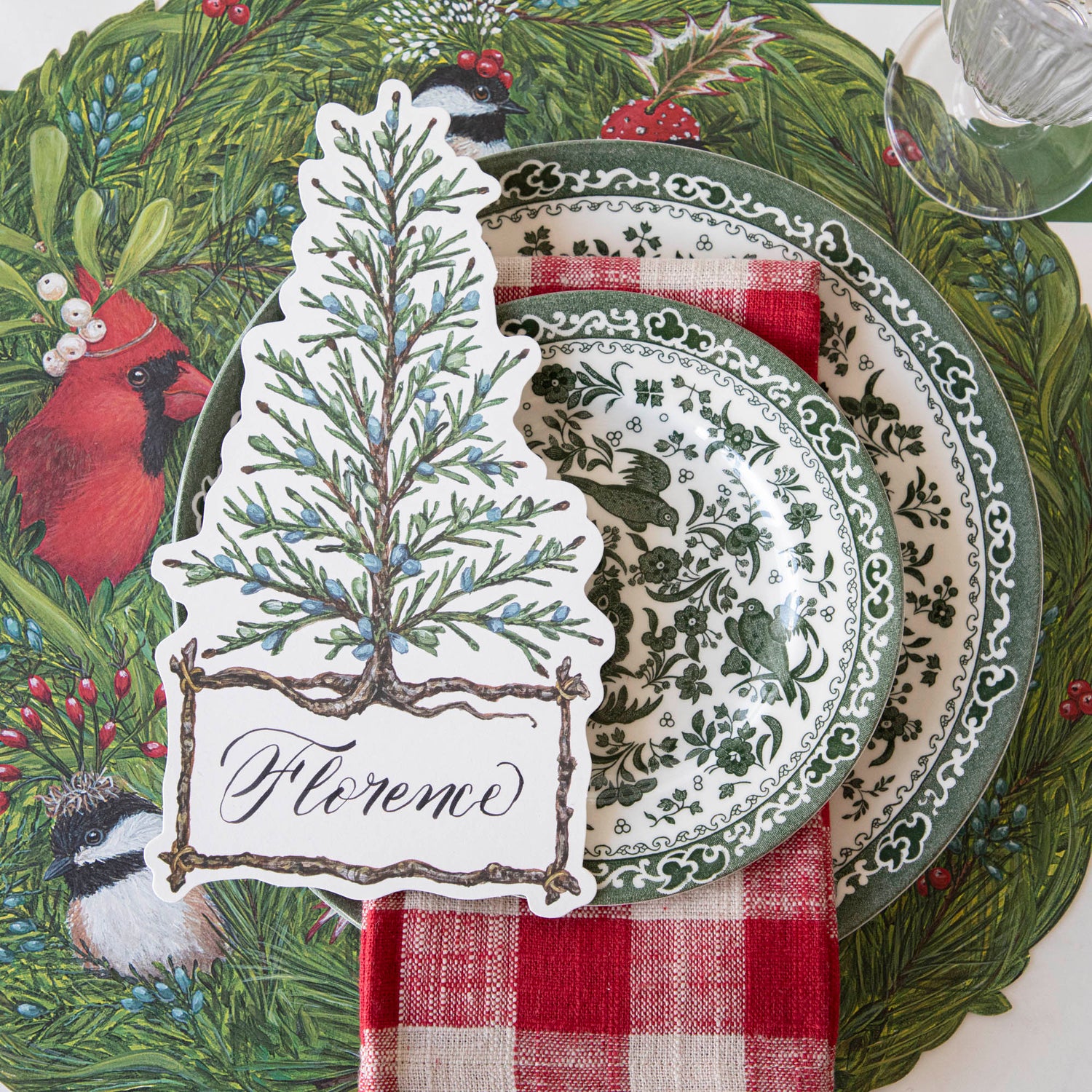 A table setting with a green and white place setting that features Burleigh&