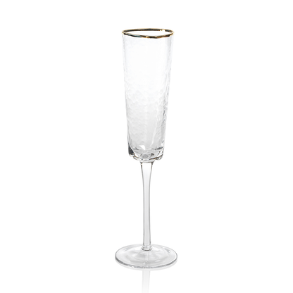 Two Zodax Hammered Glasses with Gold Rim on a tray with a bottle of champagne in the background.