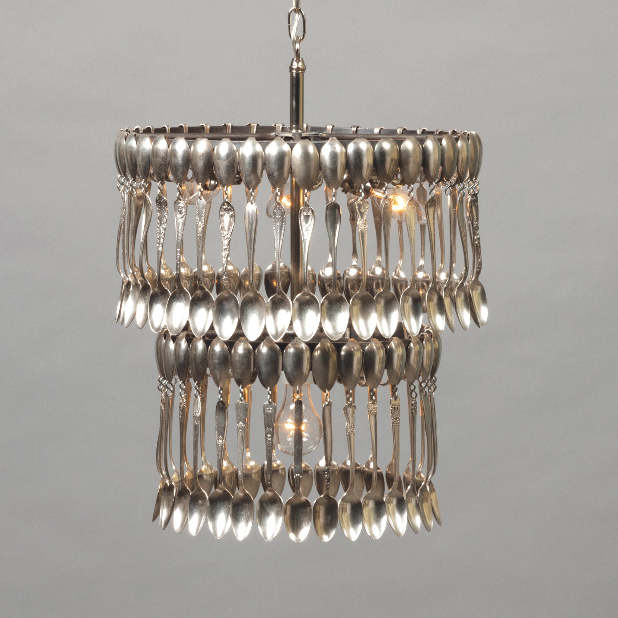 Double Tier Spoondelier made from repurposed vintage spoons and forks, hanging against a neutral background by Hester & Cook.