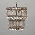 Double Tier Spoondelier made from repurposed vintage spoons and forks, hanging against a neutral background by Hester & Cook.
