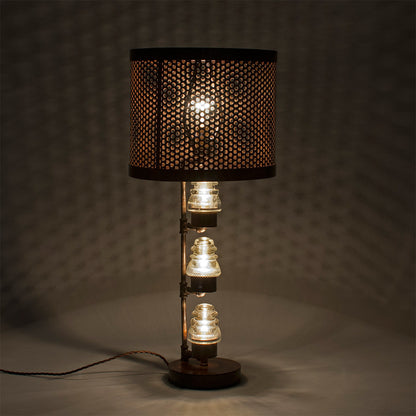 A traditional Hester &amp; Cook Telegraph Table Top Lamp with a metal shade and a basket on top.