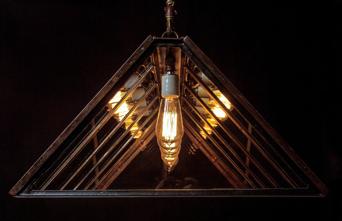 An industrial-style chandelier with five exposed vintage Edison bulbs by Hester &amp; Cook&