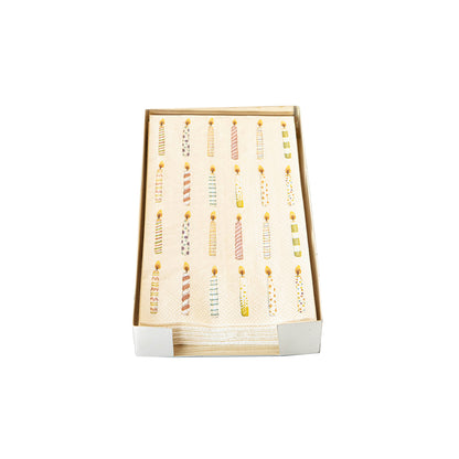 A Silver Guest Napkin Holder containing birthday candle napkins on a white table.