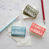 A selection of Cambridge Imprint Arabesque Thank You Cards with intricate designs next to two pencils, crafted on FSC-certified stock.