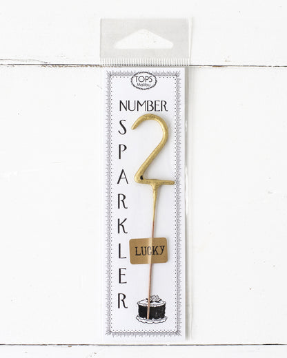 An instant party package featuring a 4&quot; tall Gold Number Cake Topper Sparklers from Tops Malibu.