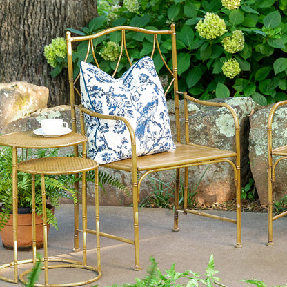 A Park Hill metal bamboo porch chair with a blue and white patterned cushion in a garden setting with a matching side table and cup.