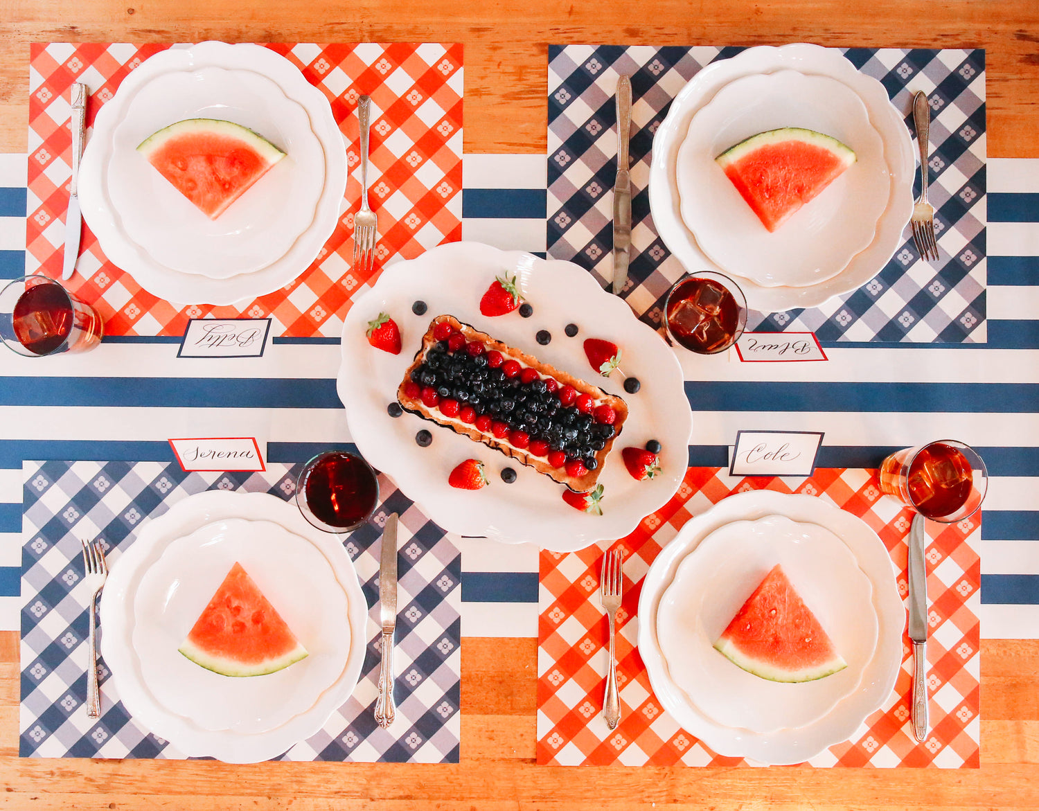 The red and blue Picnic Check Placemats under a picnic-themed table setting for four, from above.