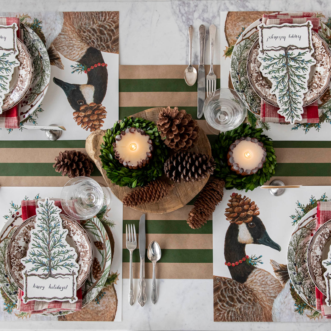 The Festive Geese Placemat under a festive winter table setting for four, from above. 