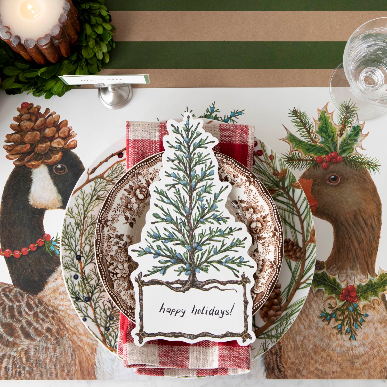The Festive Geese Placemat under a festive winter-themed place setting, from above.