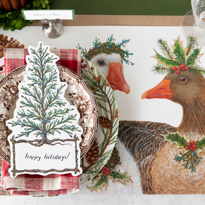 The Festive Geese Placemat under a festive winter-themed place setting, from above.