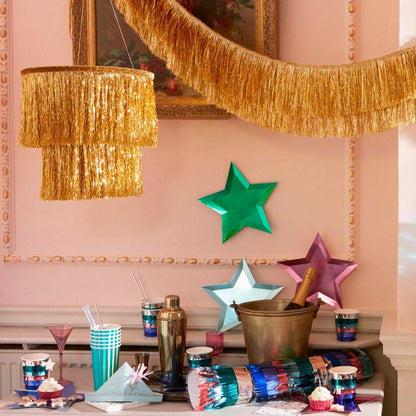 A table with a champagne bottle and glasses, adorned with Meri Meri&