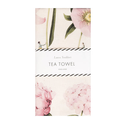 The In Bloom Pink Peony tea towel in retail packaging with a white paper belly band.