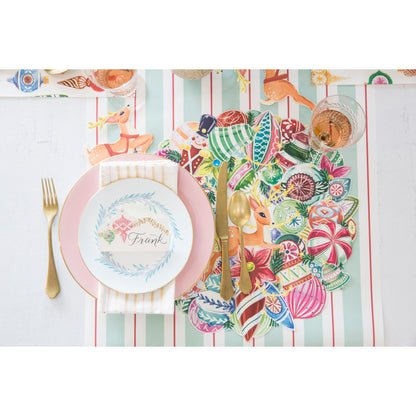 The Die-cut Yuletide Treasure Wreath Placemat under a festive holiday place setting, from above.
