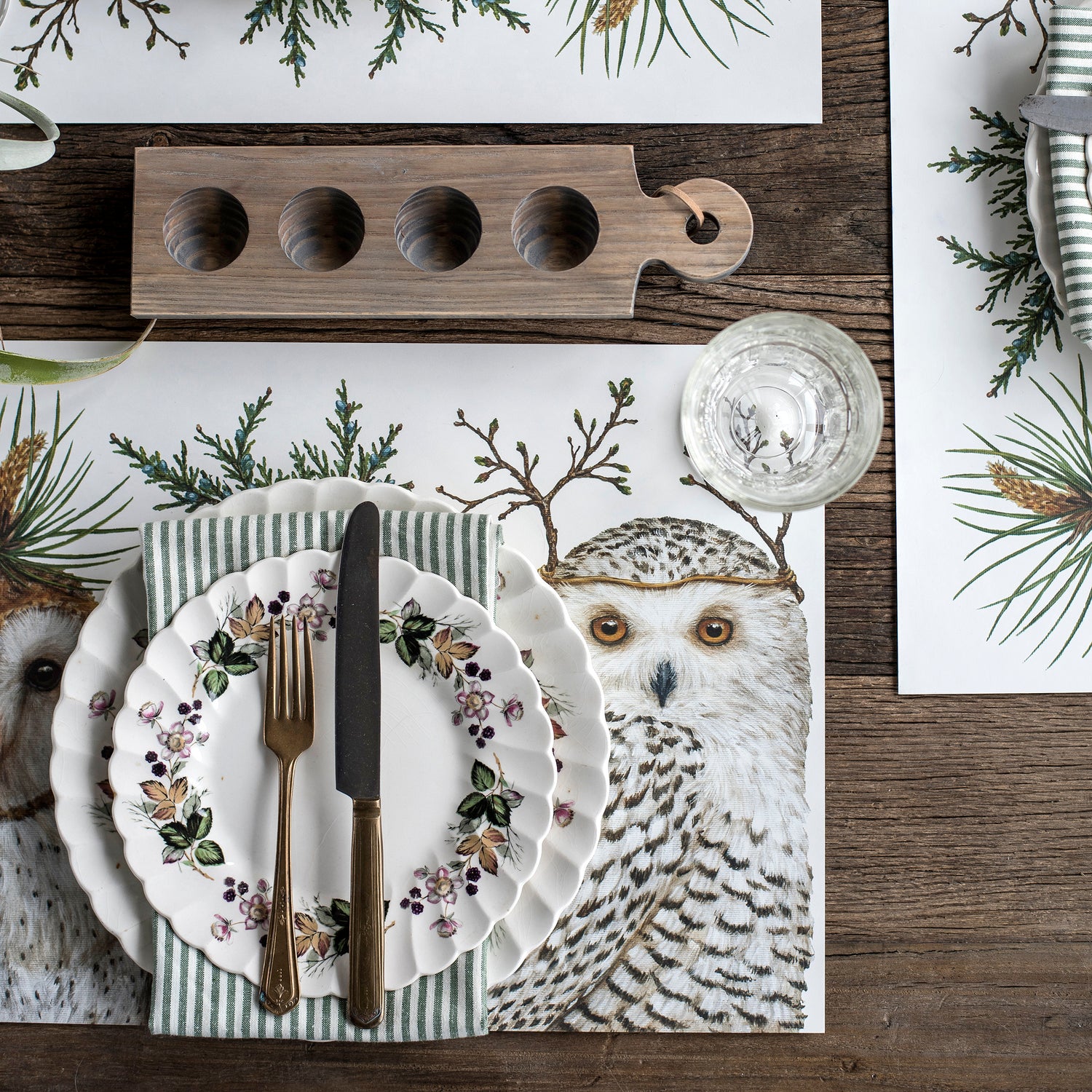 The Winter Owls Placemat under an elegant winter-themed table setting, from above.