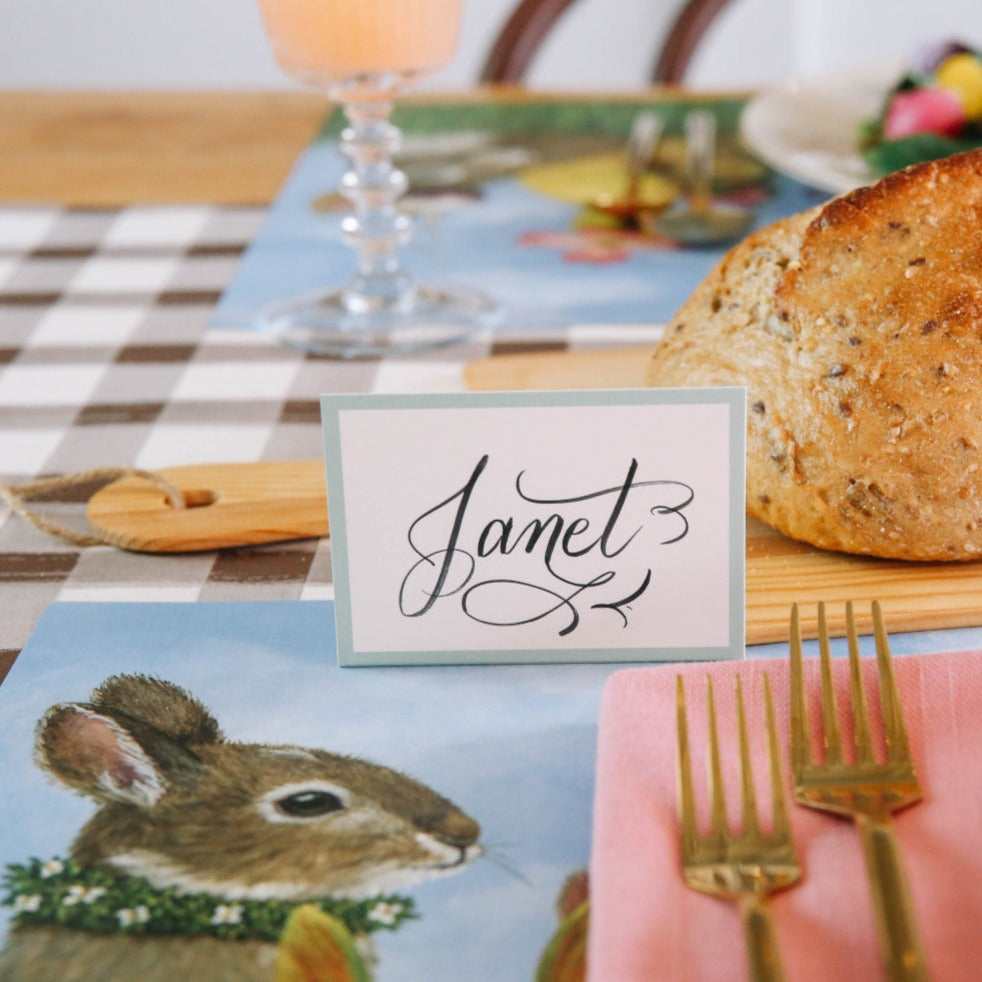 A table setting with a Seafoam Frame Place Card labeled place cards for guests from Hester &amp; Cook.