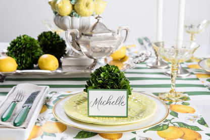 A meticulously assembled table setting with Preserved Boxwood Sphere from Accent Decor and lush greenery.