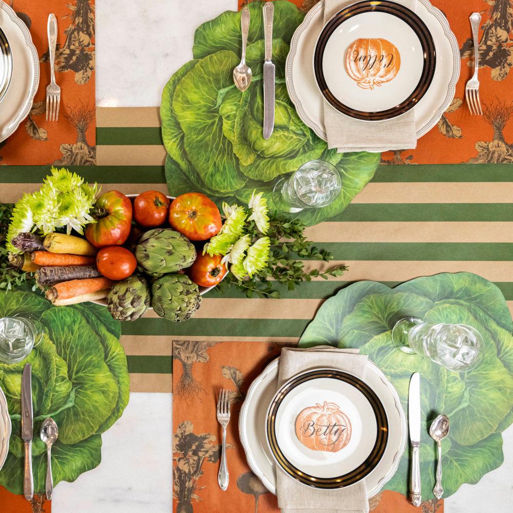 The Kraft Green Classic Stripe Runner under an rustic vegetable-themed table setting for four, from above.